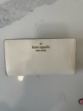 kate spade off white zip wallet with heart-print interior